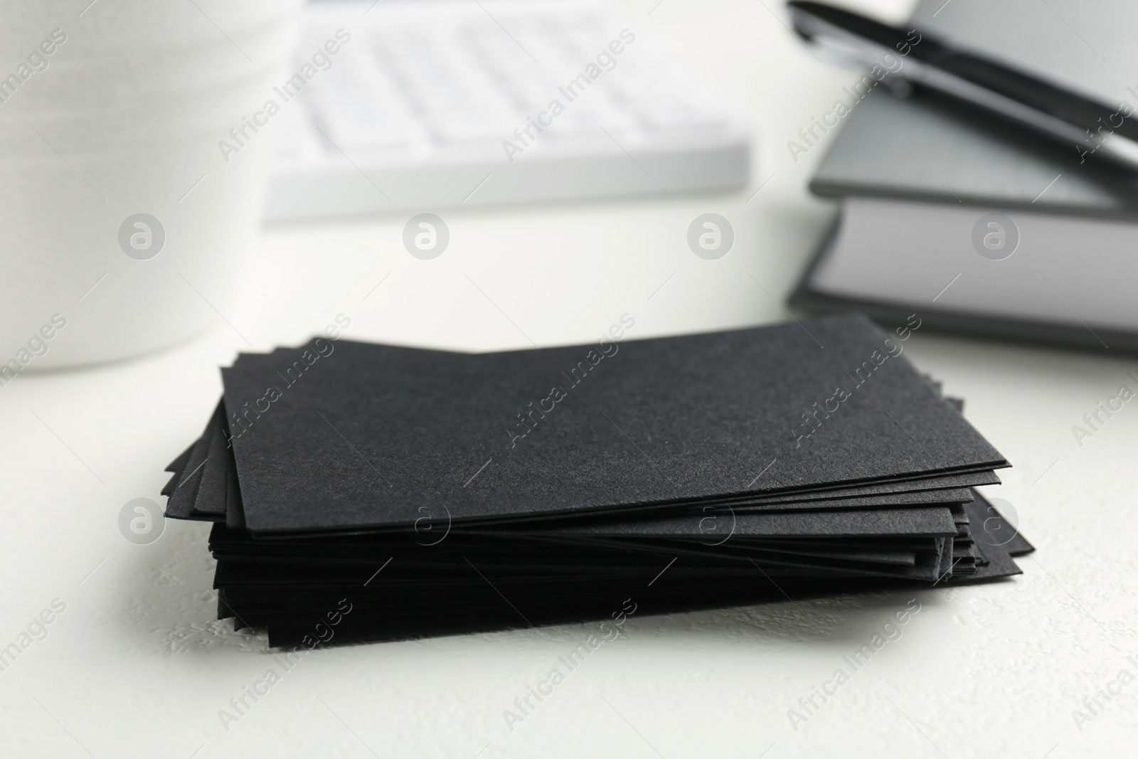 Photo of Blank black business cards on white table, closeup. Mockup for design