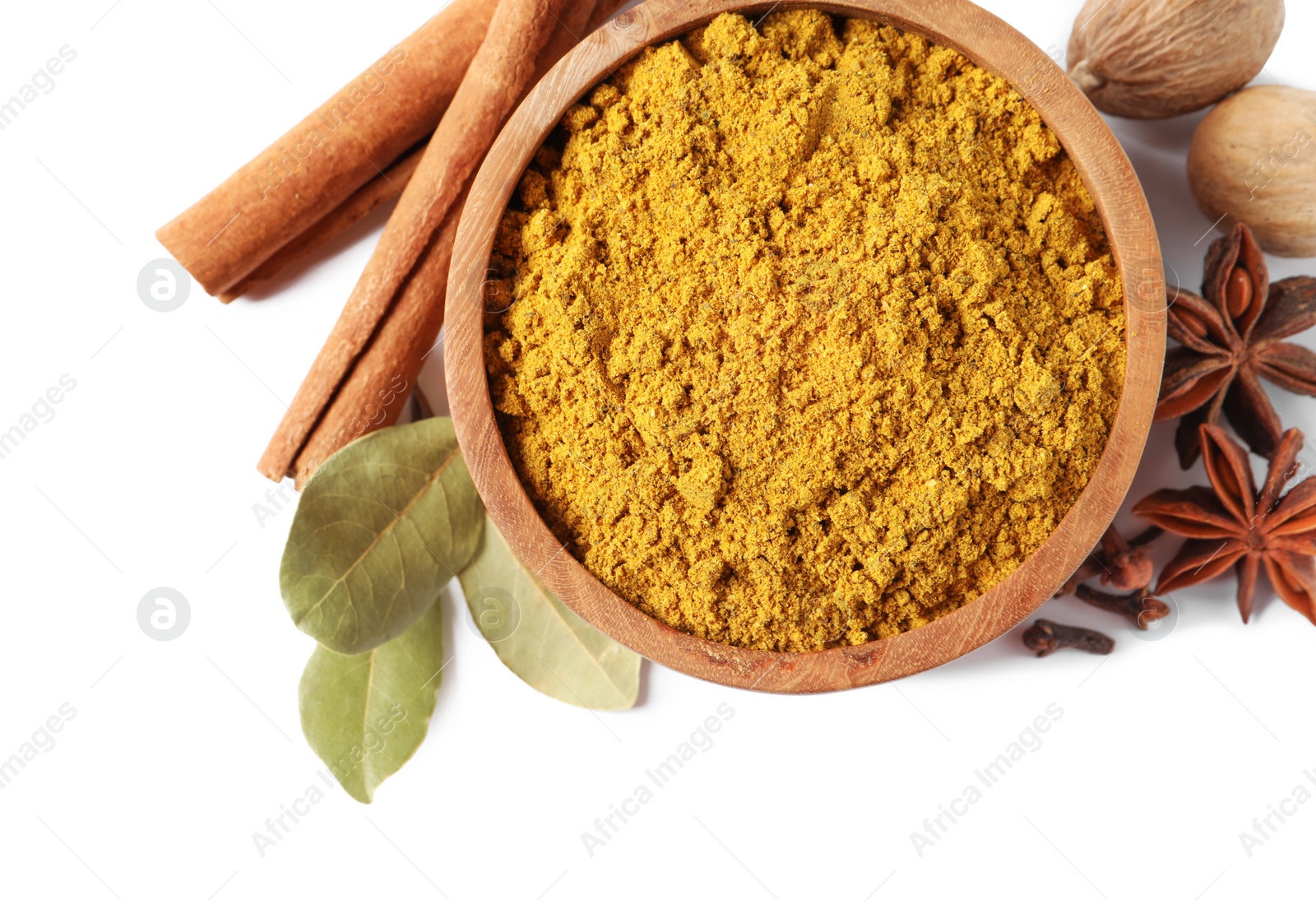 Photo of Dry curry powder in bowl and other spices isolated on white, top view