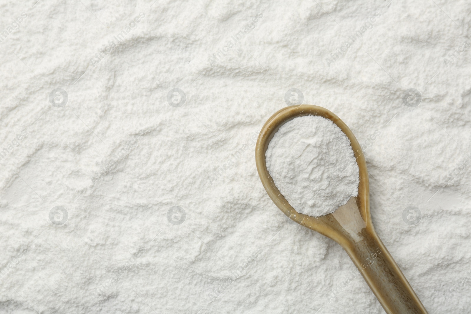 Photo of One spoon on baking powder, top view. Space for text