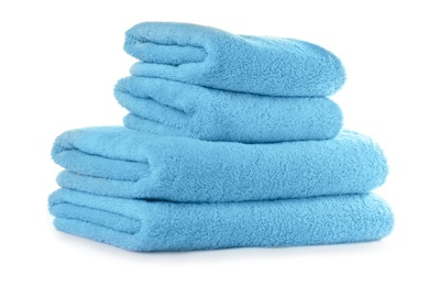 Stacked clean turquoise towels on white background