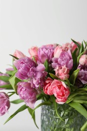 Photo of Beautiful bouquet of colorful tulip flowers against white background, closeup