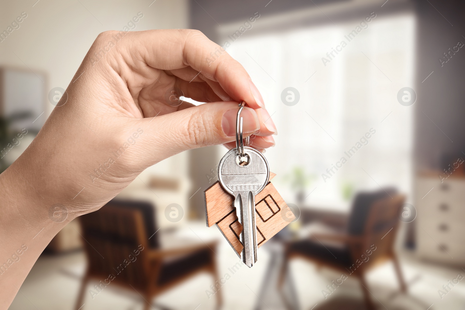 Image of Woman with key in new modern apartment, closeup