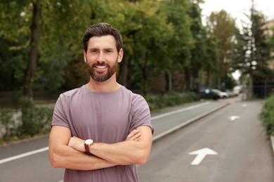 Photo of Portrait of handsome bearded man on street, space for text