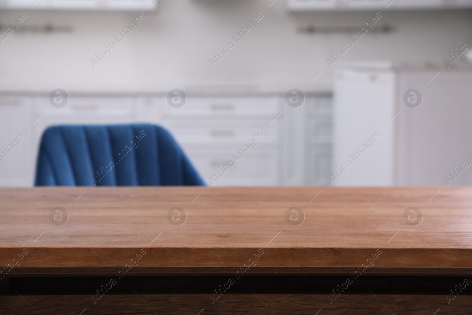 Photo of Wooden table and armchair indoors, closeup. Modern furniture