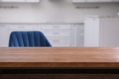 Wooden table and armchair indoors, closeup. Modern furniture