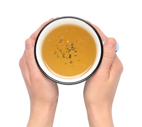 Woman with cup of hot delicious bouillon on white background, top view