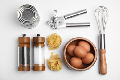 Photo of Cooking utensils and ingredients on white background, top view