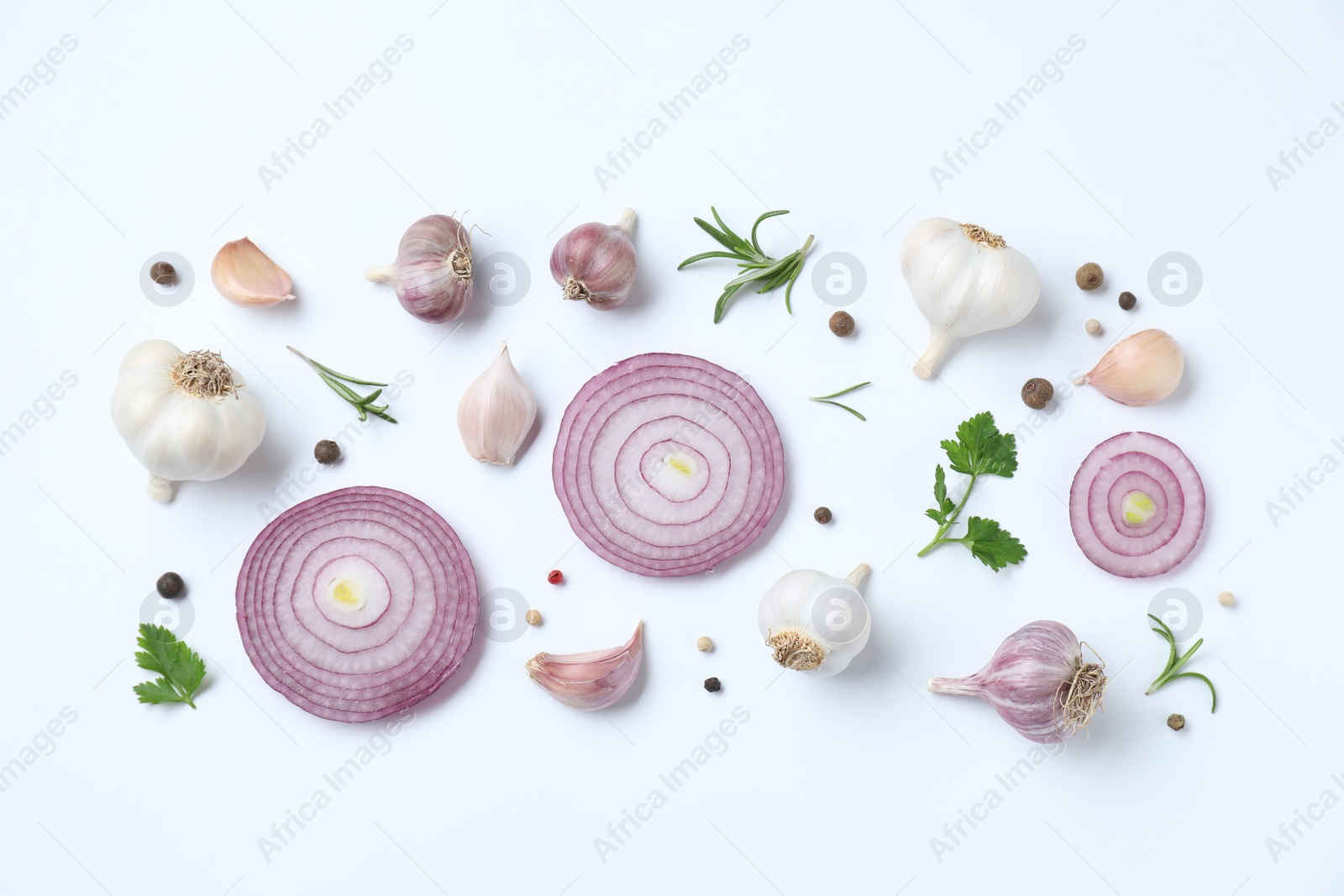 Photo of Fresh garlic, onion rings and spices on white table, flat lay