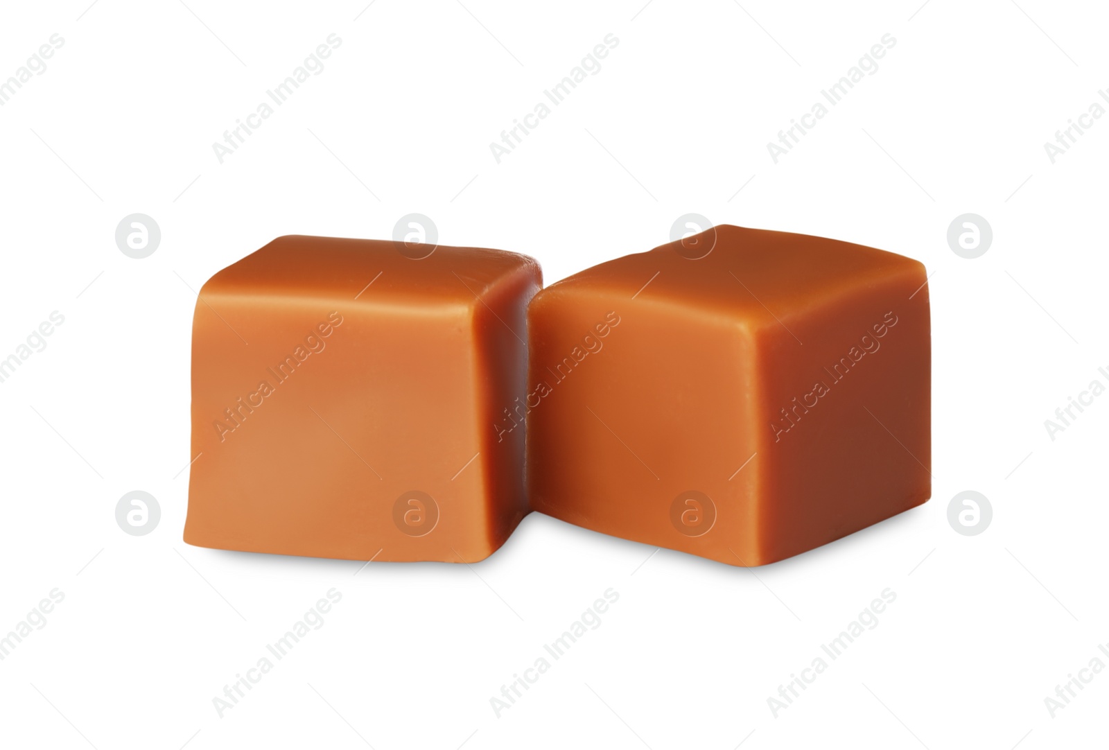 Photo of Two sweet caramel candies on white background