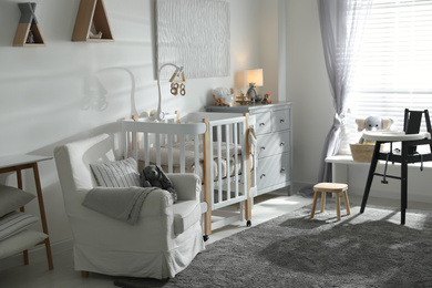 Photo of Baby room interior with crib and highchair. Idea for design