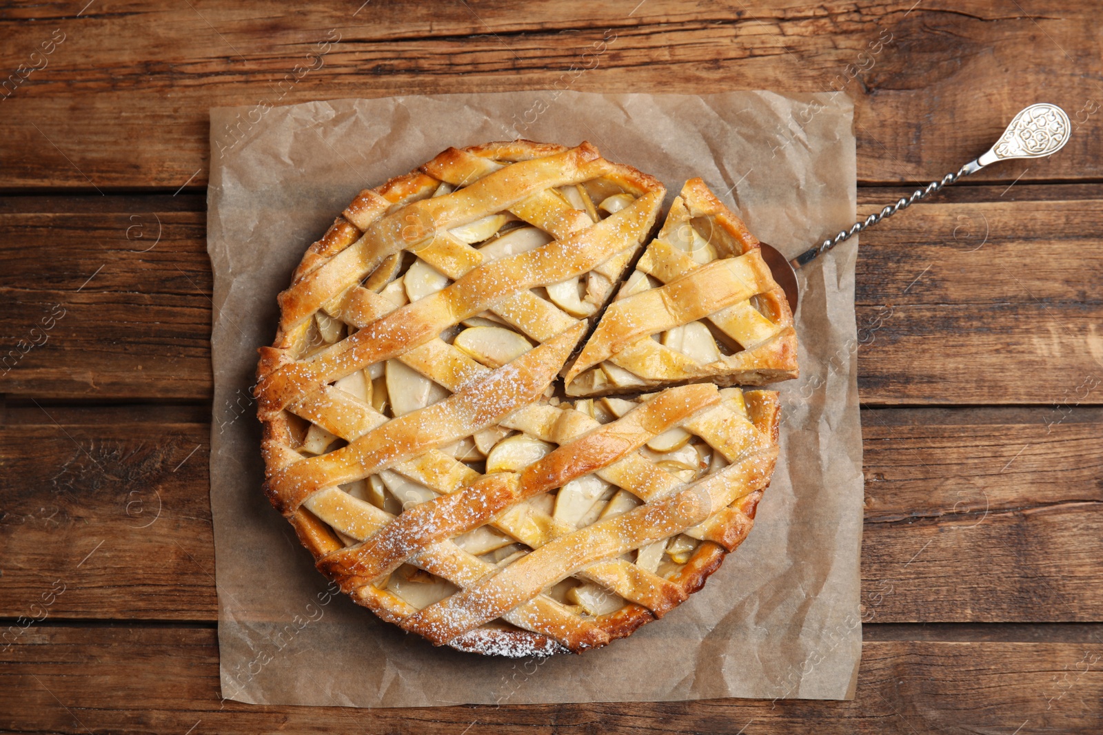 Photo of Delicious traditional apple pie on wooden table, top view