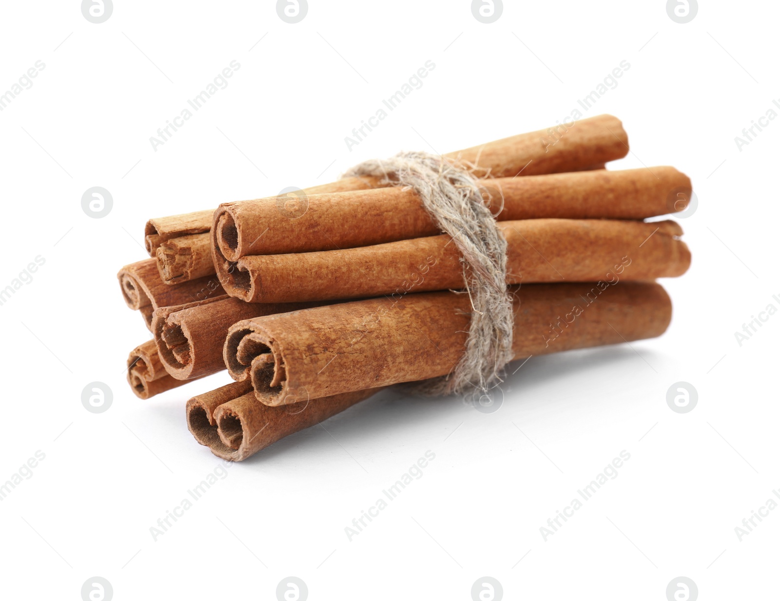 Photo of Tied cinnamon sticks on white background