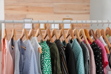 Wardrobe rack with stylish female clothes indoors
