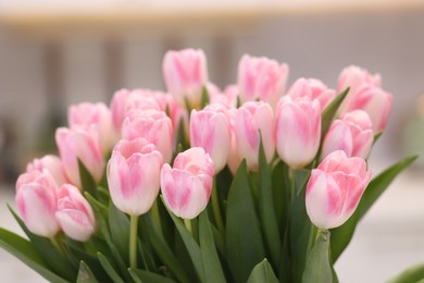 Photo of Beautiful bouquet of fresh pink tulips on blurred background, closeup