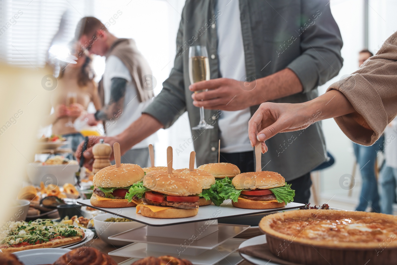 Photo of People near buffet table with food indoors, closeup. Brunch setting