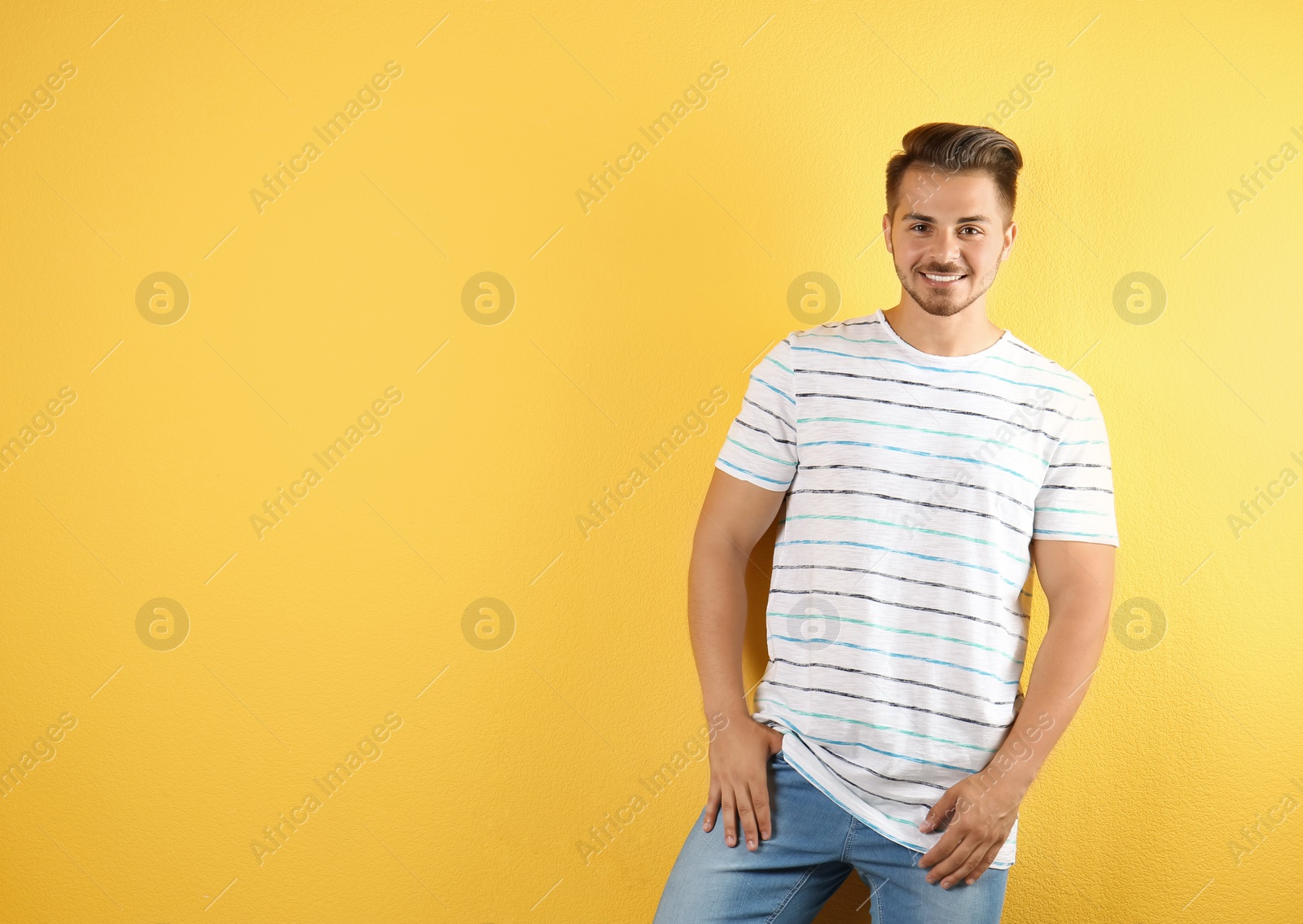 Photo of Young man in stylish jeans on color background