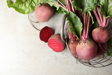 Photo of Flat lay composition with fresh red beets on light table, space for text