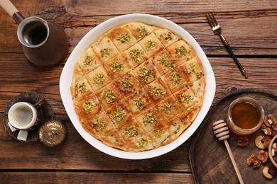 Delicious sweet baklava served on wooden table, flat lay