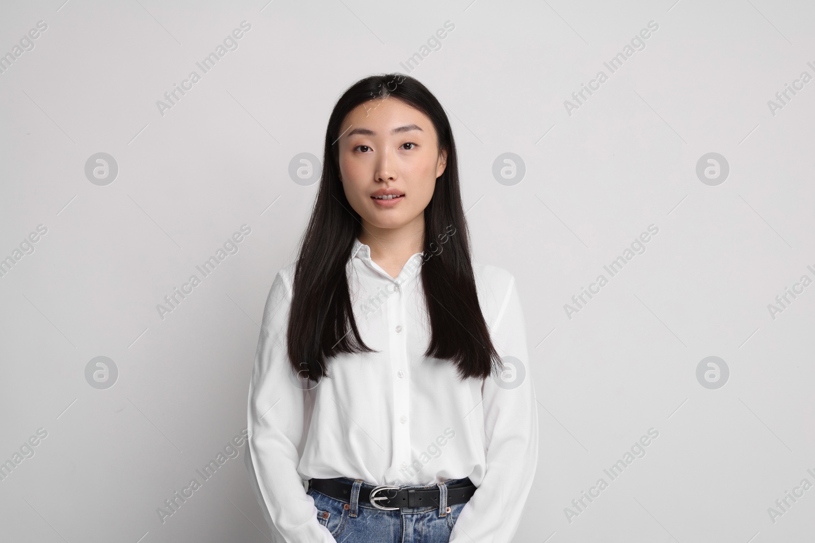 Photo of Portrait of beautiful woman on light background