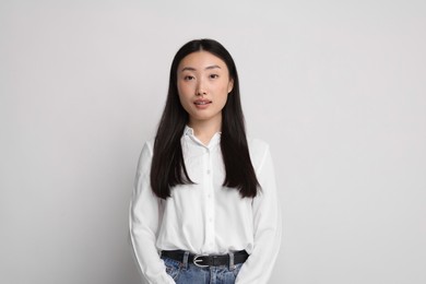 Portrait of beautiful woman on light background