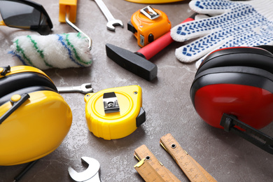 Many different construction tools on grey marble table