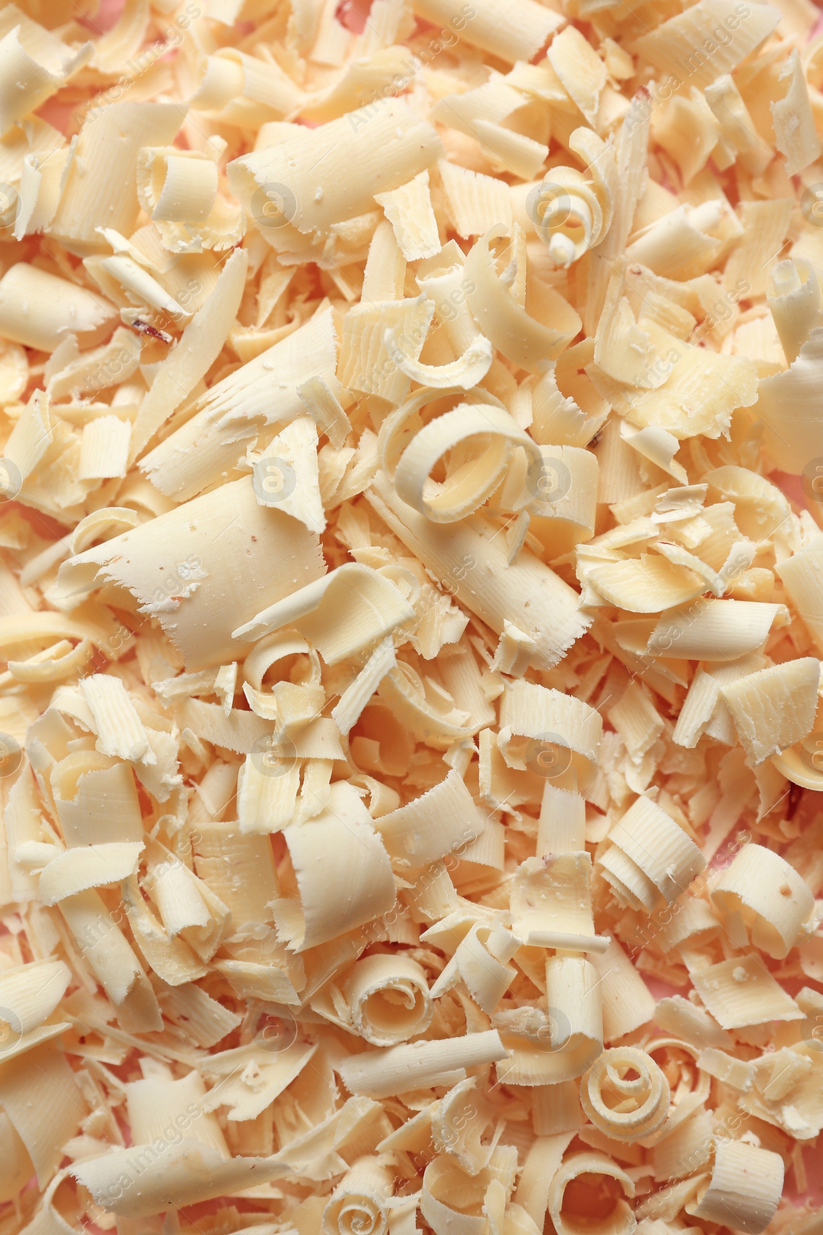 Photo of Pile of white chocolate curls as background, top view