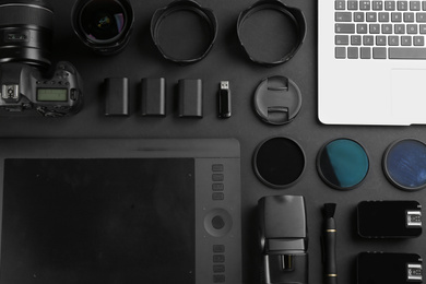Photo of Flat lay composition with equipment for professional photographer on black background