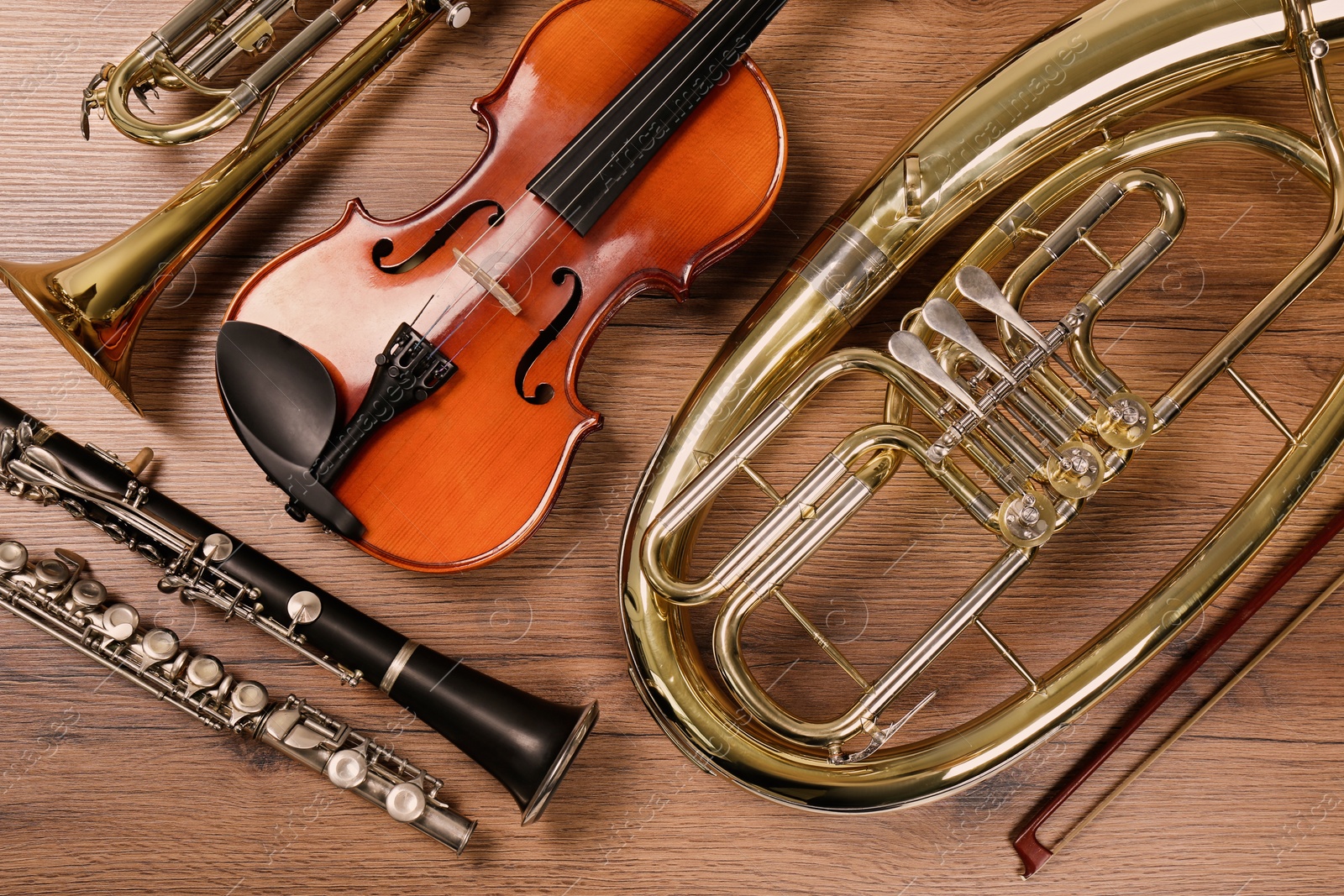 Photo of Set of different musical instruments on wooden background, flat lay