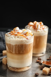 Photo of Glasses with delicious caramel frappe on tray