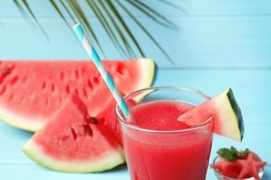 Photo of Summer watermelon drink in glass on table, closeup