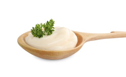 Photo of Wooden spoon with tasty mayonnaise and parsley isolated on white