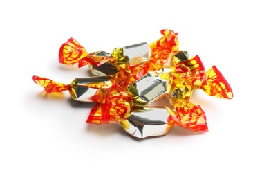 Delicious candies wrapped in foil on white background