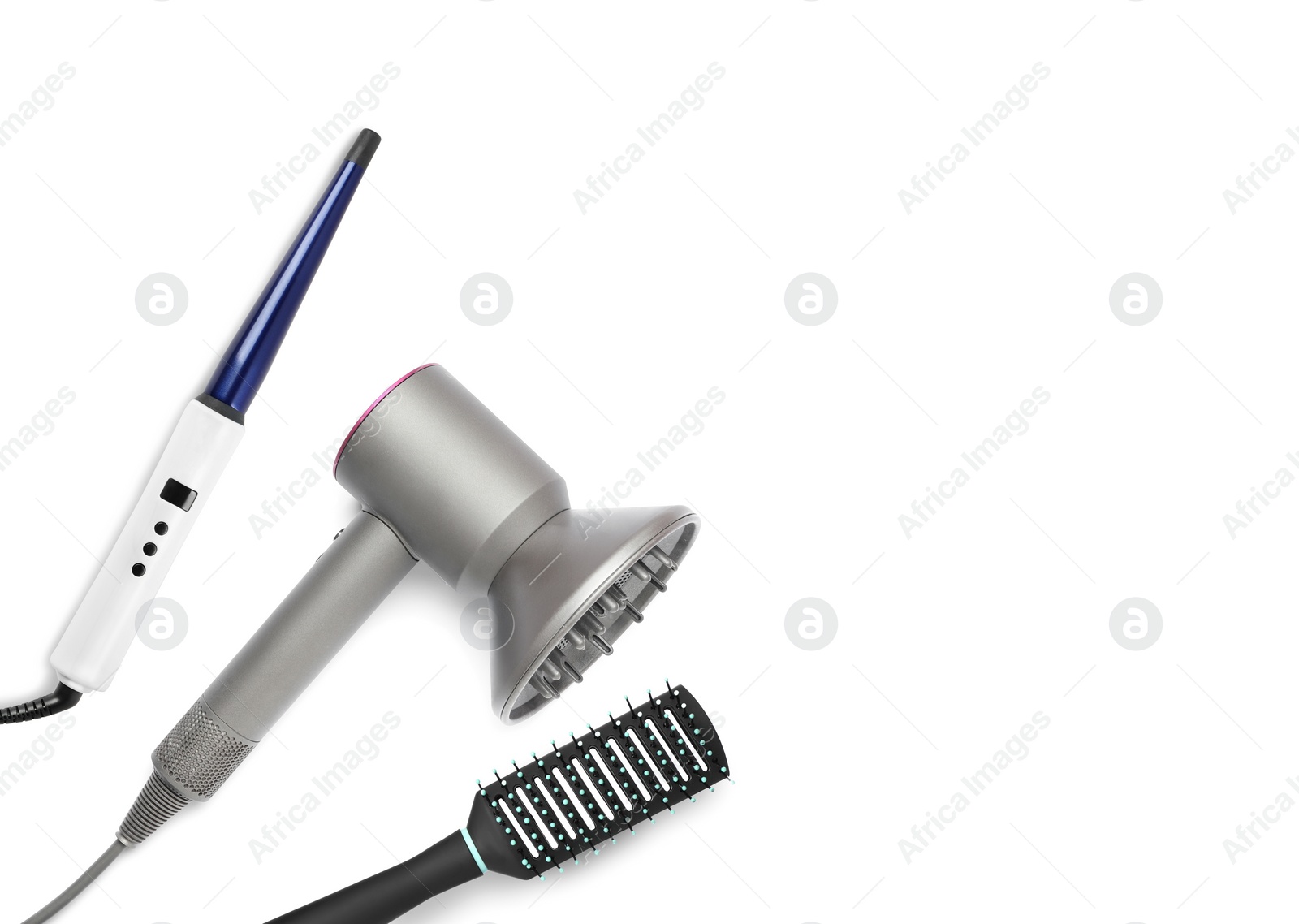 Image of Hair dryer, curling iron and brush on white background, top view