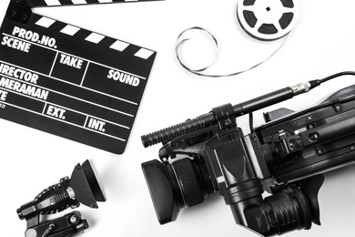 Photo of Flat lay composition with video camera and other equipment on white background