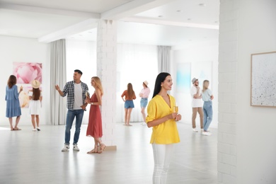 Photo of Group of people at exhibition in art gallery