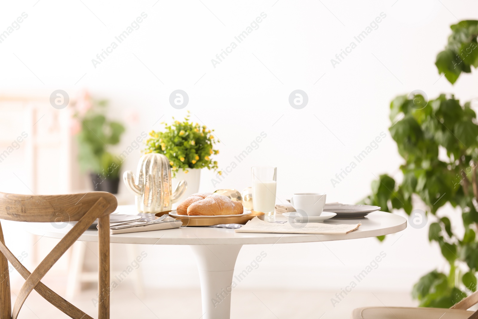 Photo of Tasty breakfast with fresh croissants on table