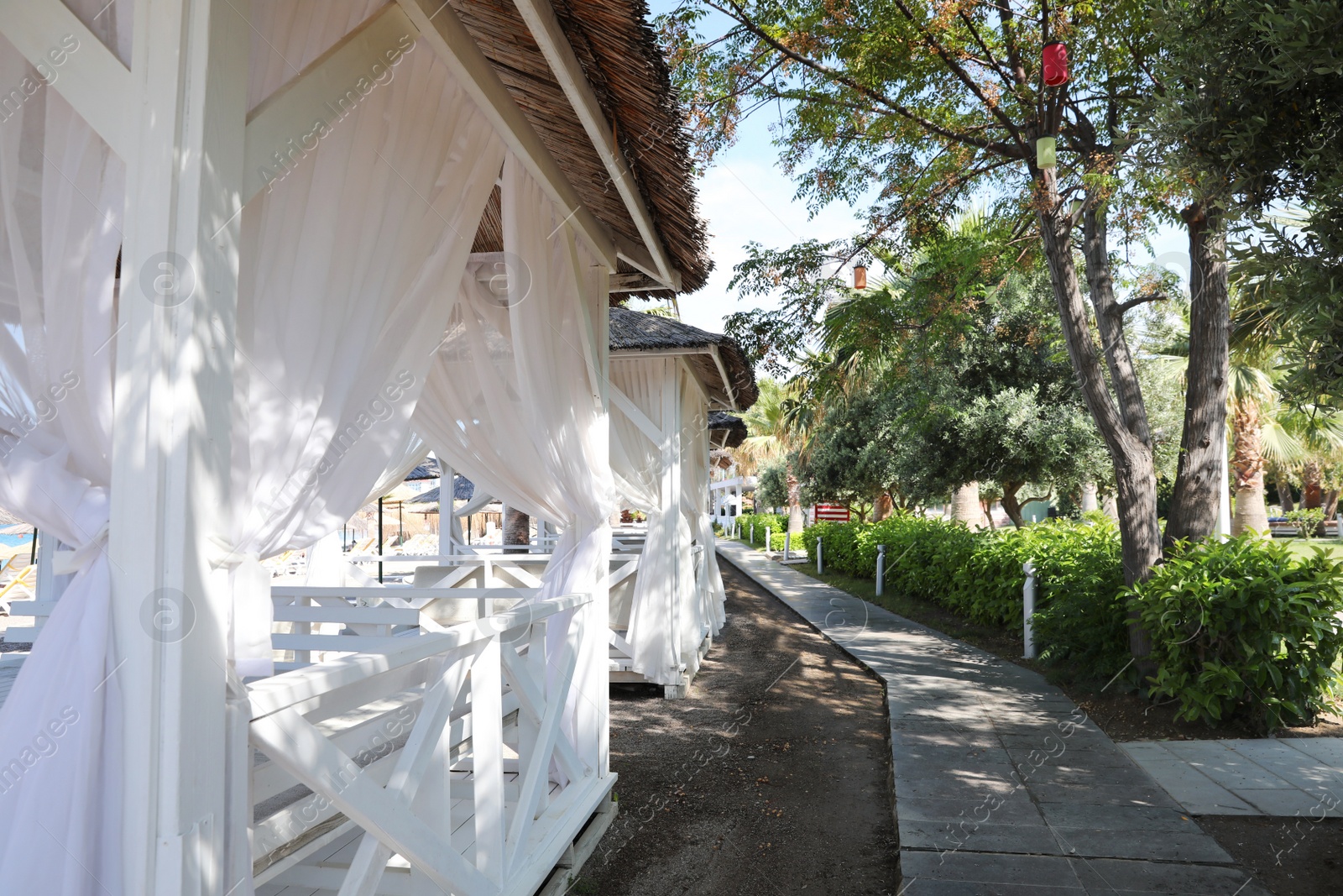 Photo of Beach huts at resort on sunny summer day