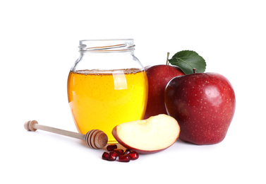 Photo of Honey, apples and pomegranate seeds on white background. Rosh Hashanah holiday