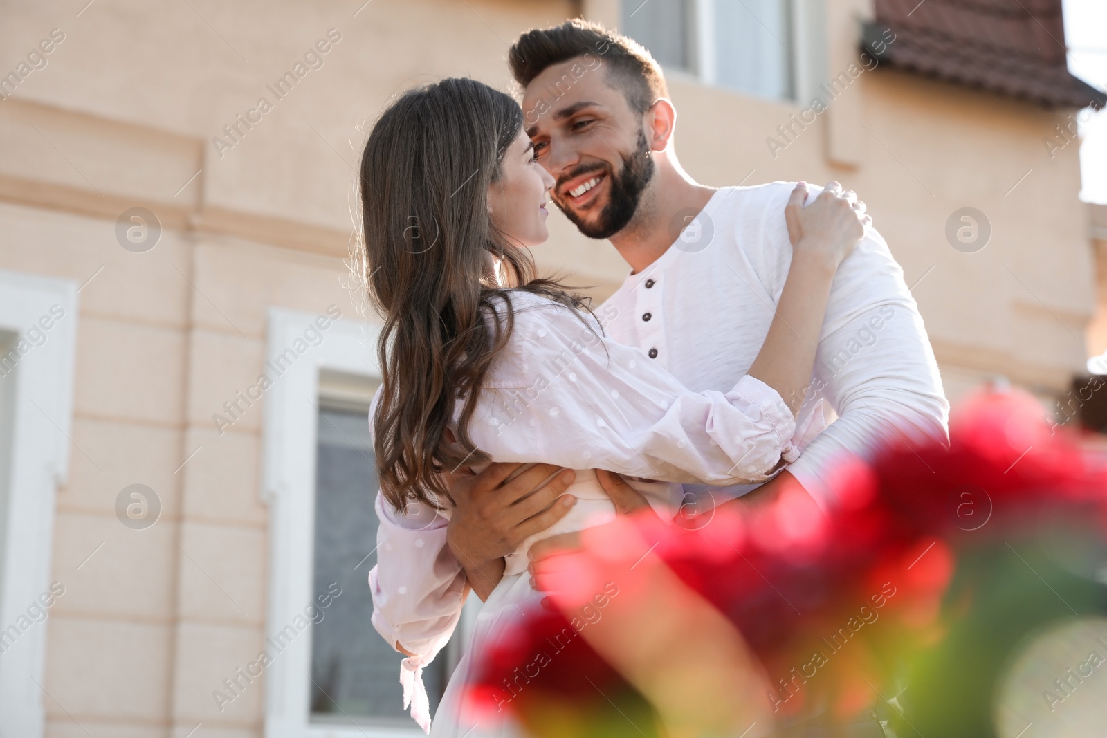 Photo of Lovely young couple dancing together outdoors on sunny day