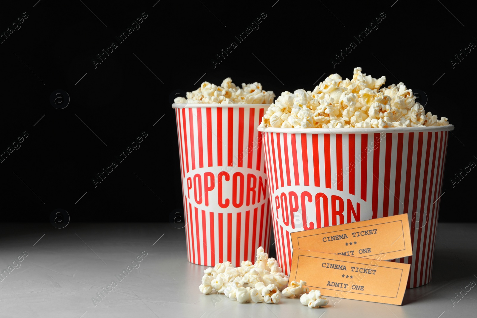 Photo of Popcorn and cinema tickets on grey table