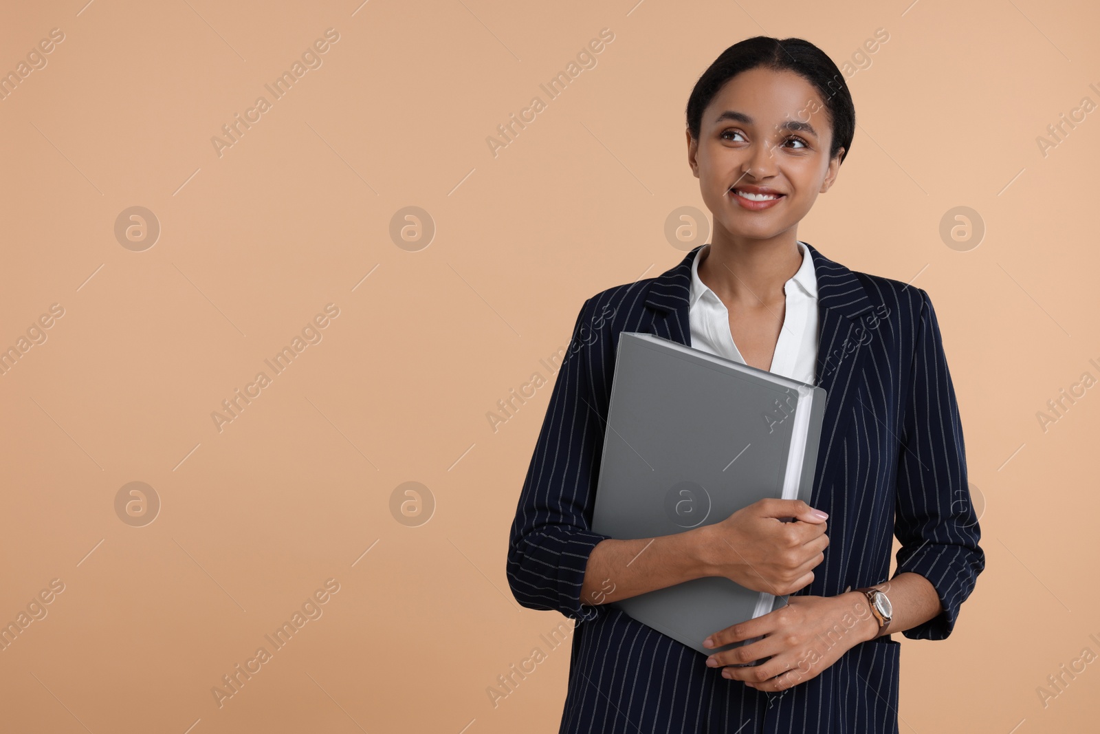Photo of Beautiful secretary with folder on beige background, space for text