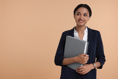 Photo of Beautiful secretary with folder on beige background, space for text