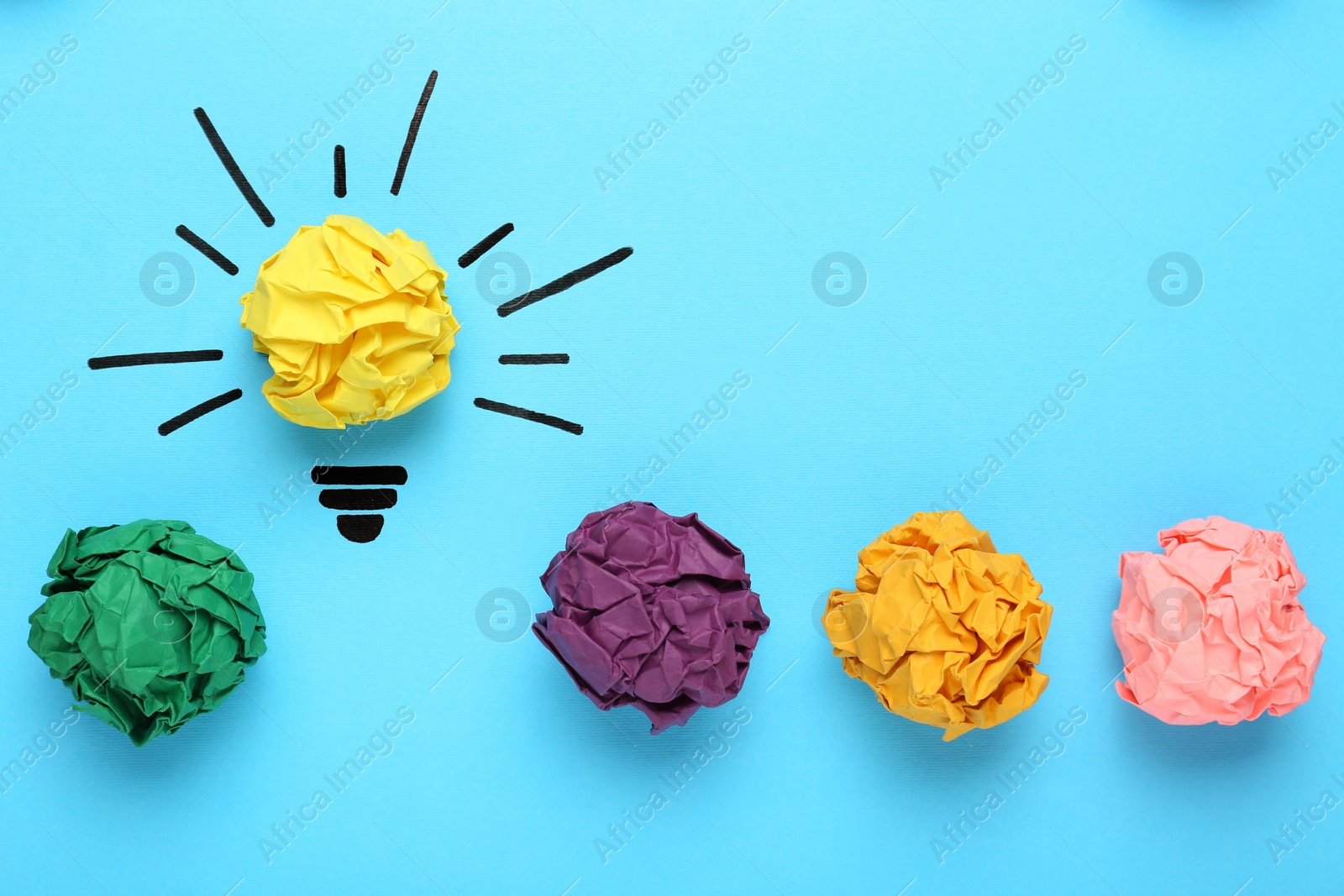 Photo of Creative flat lay composition with colorful paper balls on light blue background. Idea concept