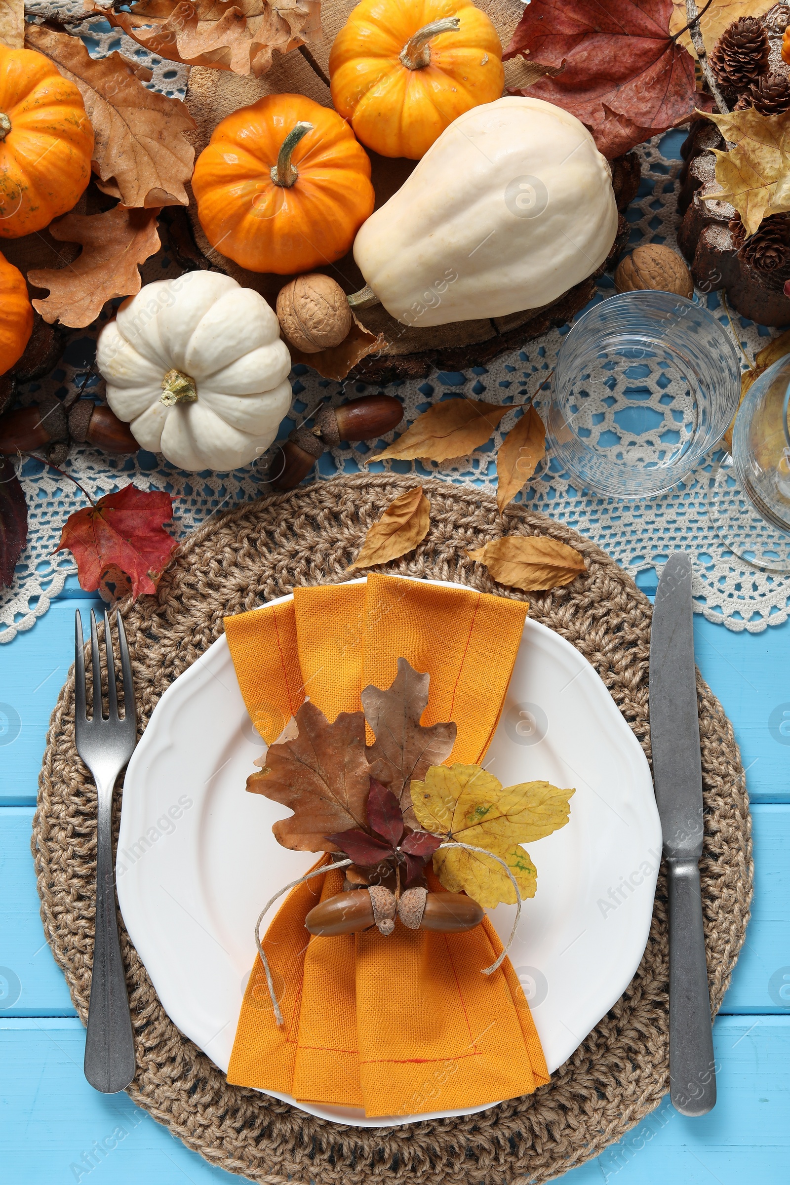 Photo of Happy Thanksgiving day. Beautiful table setting with autumn decor on light blue wooden background