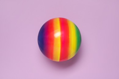 Photo of New bright kids' ball on lilac background, top view