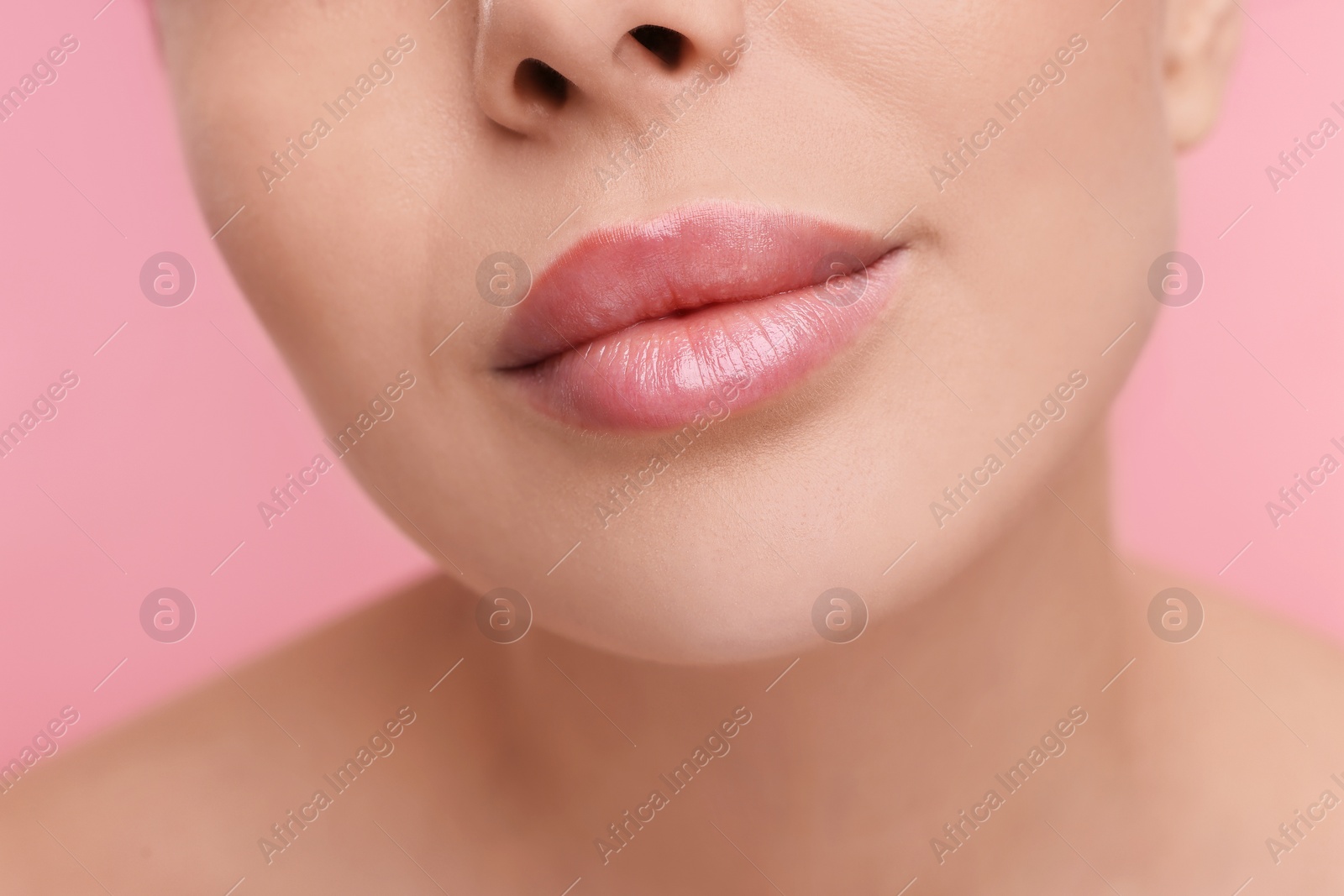 Photo of Woman with beautiful lips on pink background, closeup