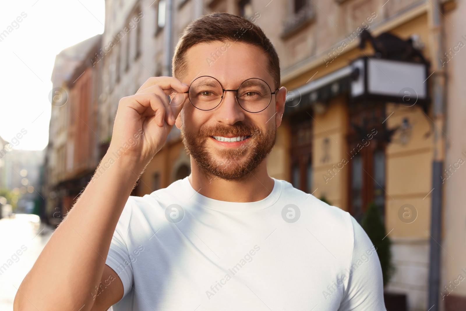 Photo of Portrait of handsome bearded man in glasses outdoors