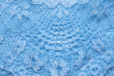 Photo of Light blue lace as background, top view