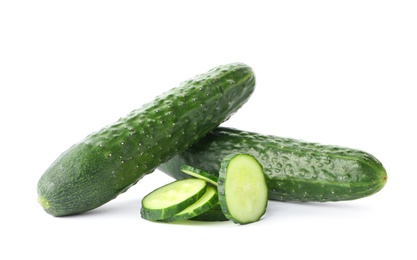 Photo of Whole and sliced fresh cucumbers on white background