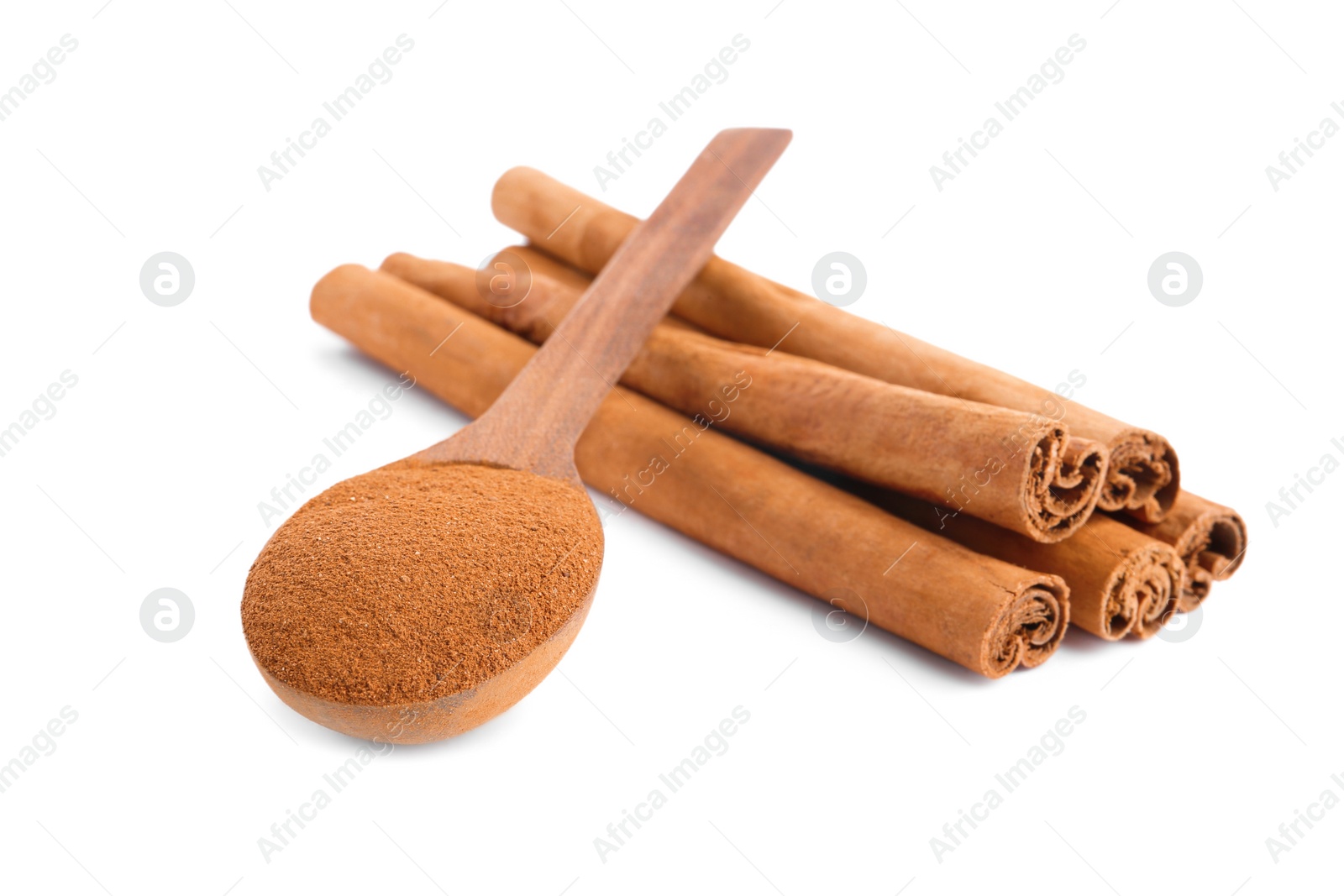 Photo of Aromatic cinnamon sticks and spoon with powder on white background